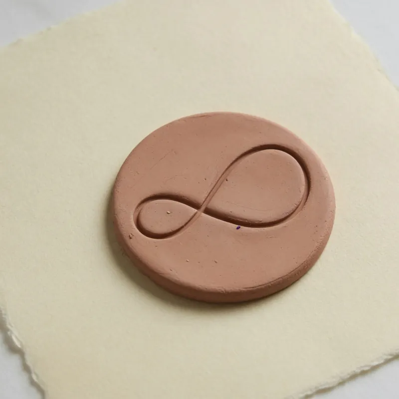 A round clay seal on warm paper — the mark carried by Brain Club’s legal pages.